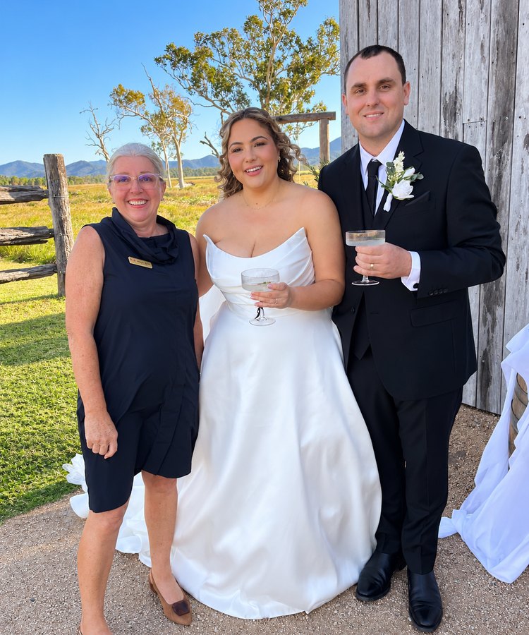 Leanne celebrating with a newly married couple at a country wedding