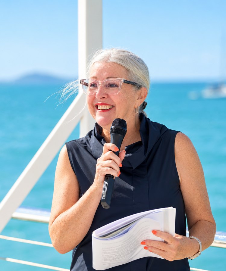 Leanne, marriage celebrant, speaking at a ceremony by the water
